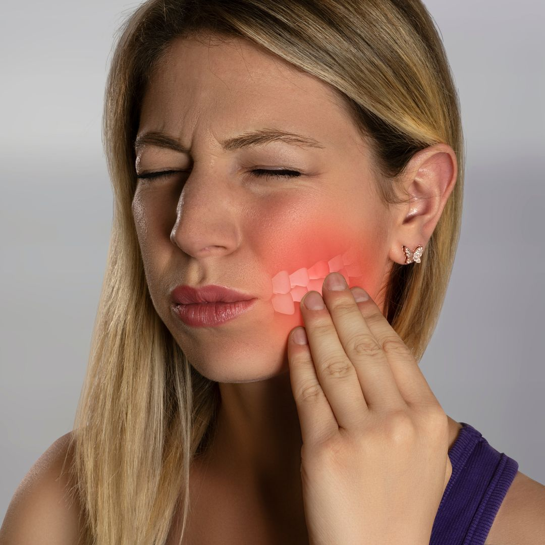 Woman touching her jaw in pain from bone loss